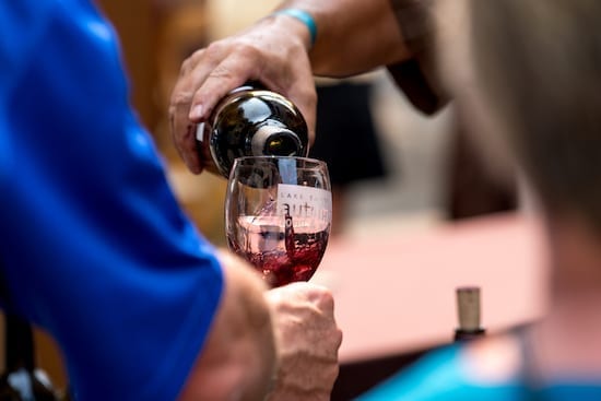 pouring wine at autumn food and wine