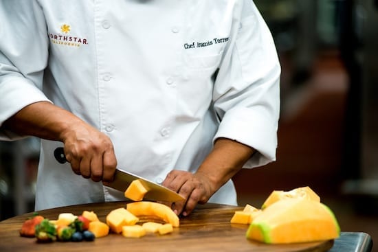 A chef is cutting food at Lake Tahoe Autumn Food & Wine Festival