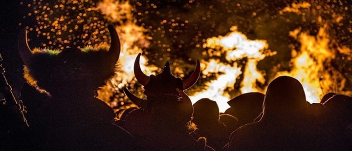 Partygoers in Ullr hats watch a bonfire at Ullr Fest in Lake Tahoe