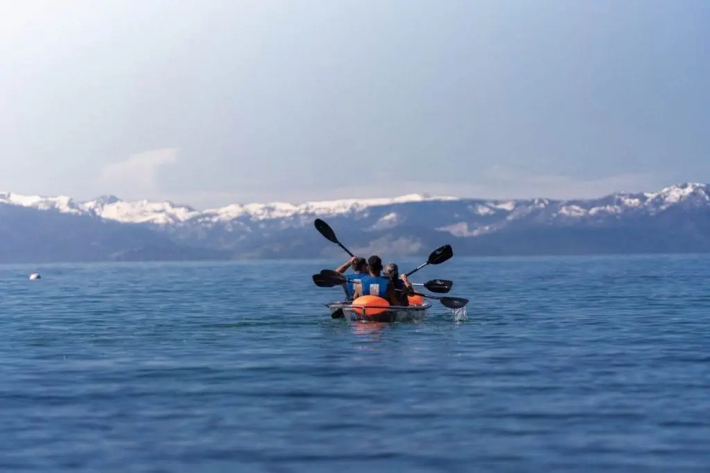 Kayaking on Lake Tahoe with snowy mountains