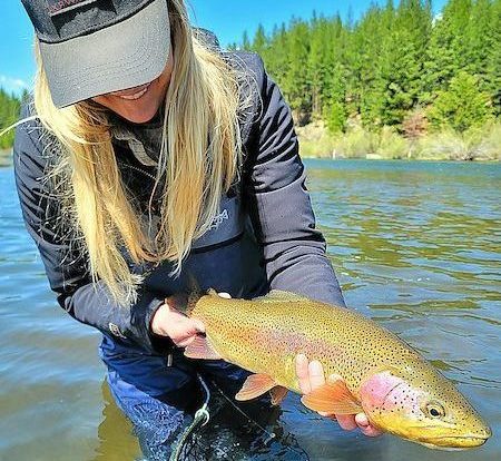 Woman holding rainbow trout in Lake Tahoe