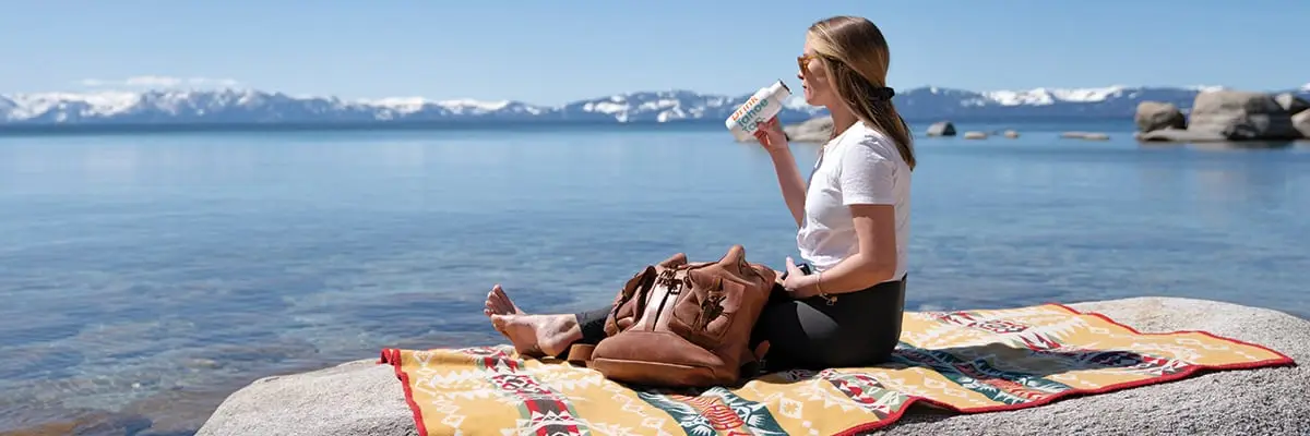 Woman on a rock drinking water